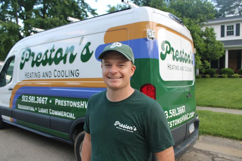 Preston's technician standing in front of company van