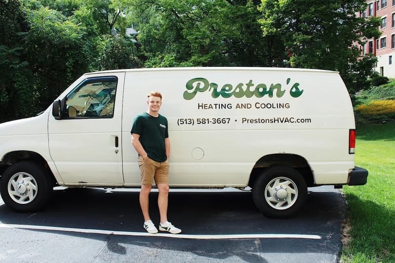 Technician leaning against white Preston's van